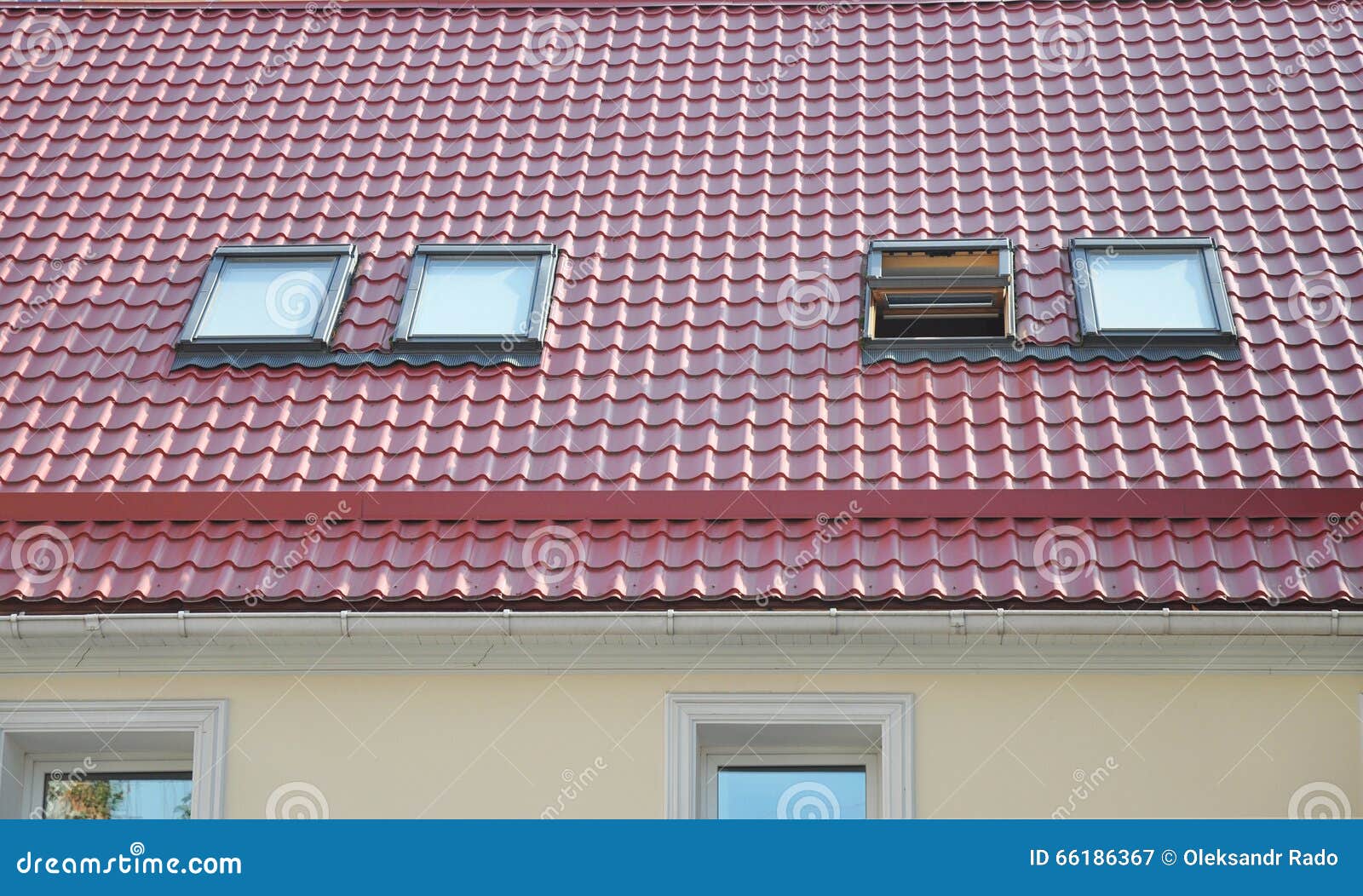 red metal tiled roof with new dormers, roof windows, skylights, rain gutter system and roof protection from snow board