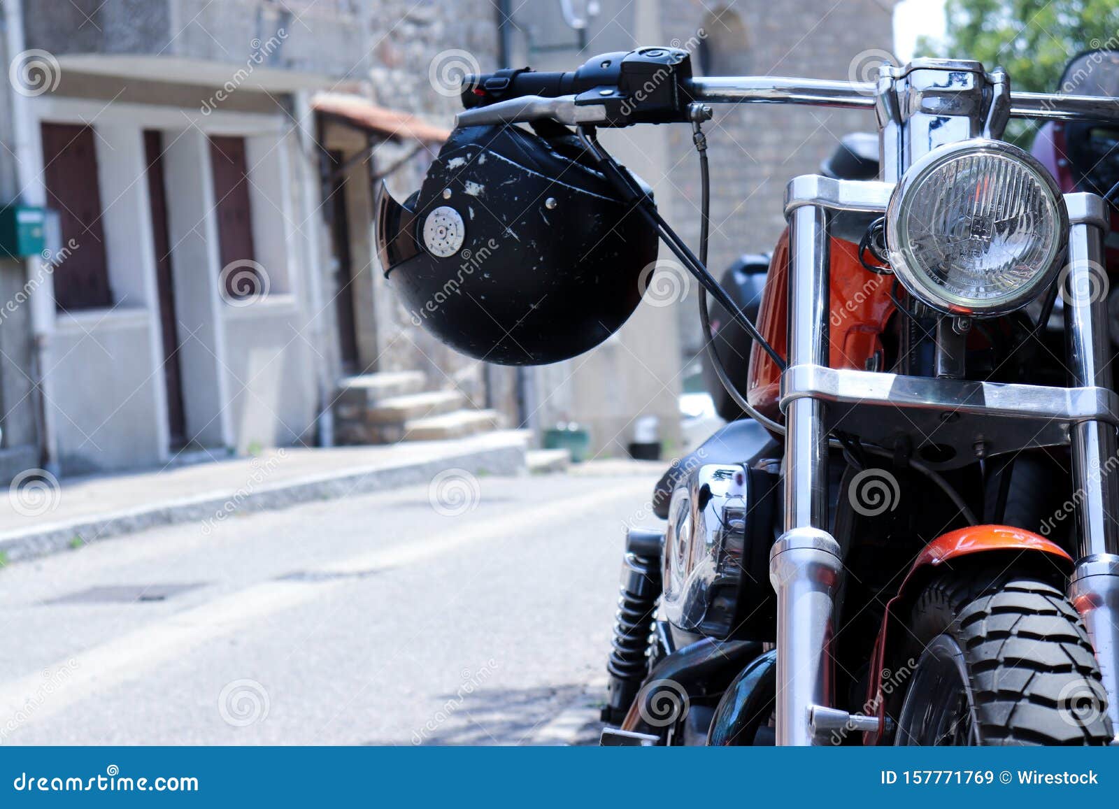 Red Motorcycle with a Helmet Hanging Off the Handlebars Shot from the