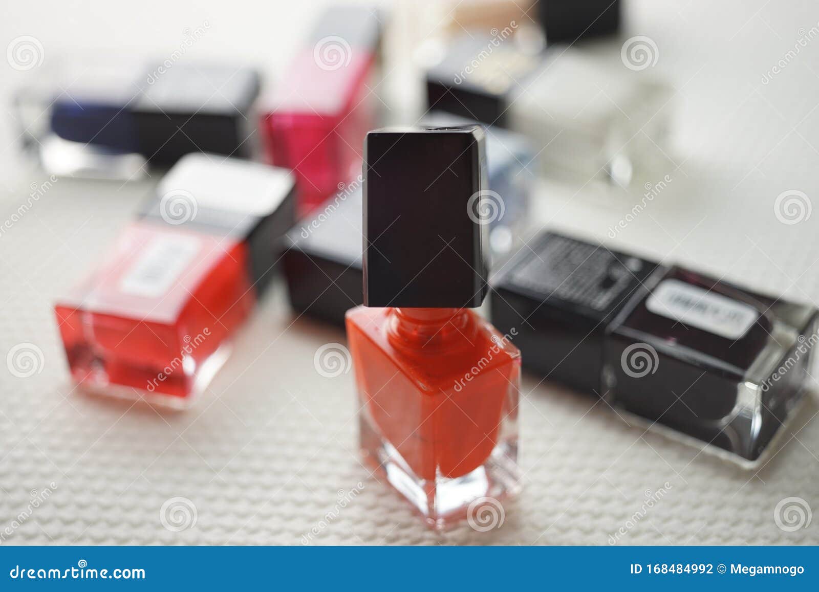 Red Nail Polish. Open Glass Bottle with a Bunch of Closed Bottles of ...