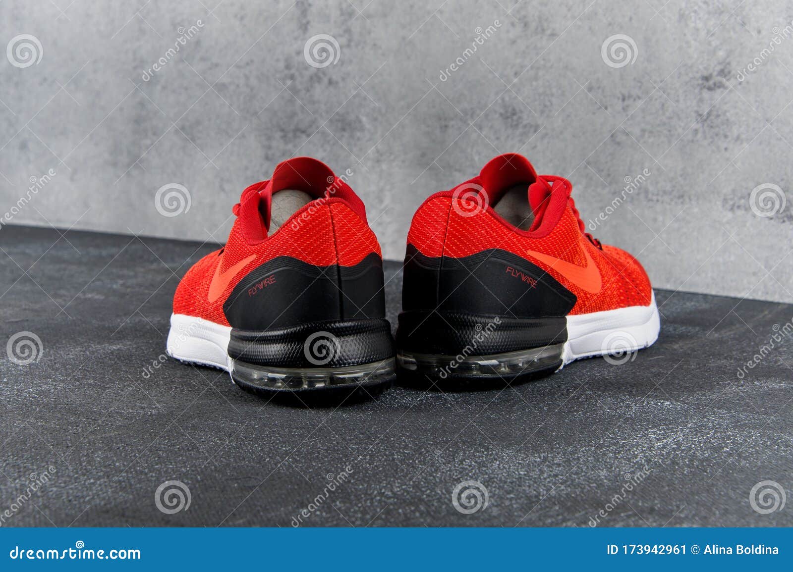 grey and red nike trainers