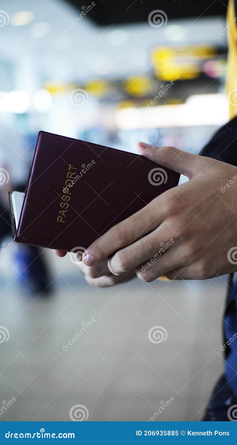 red passport open at the airport by white hands