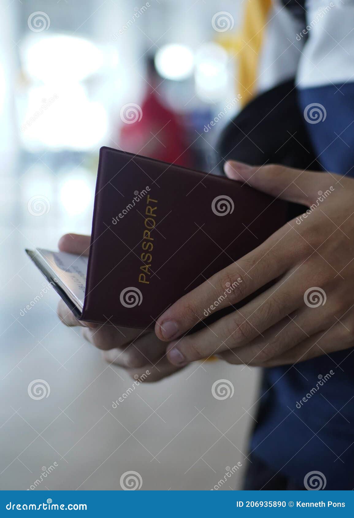 red passport open at the airport by white hands