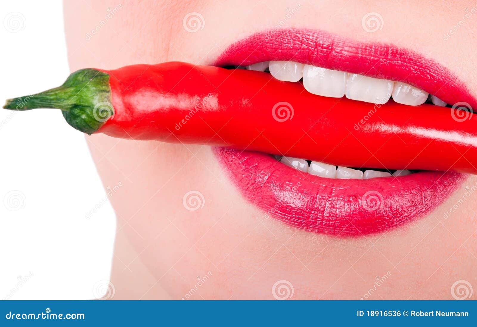 A Red Pepper between the Teeth Stock Photo Image of season, lips
