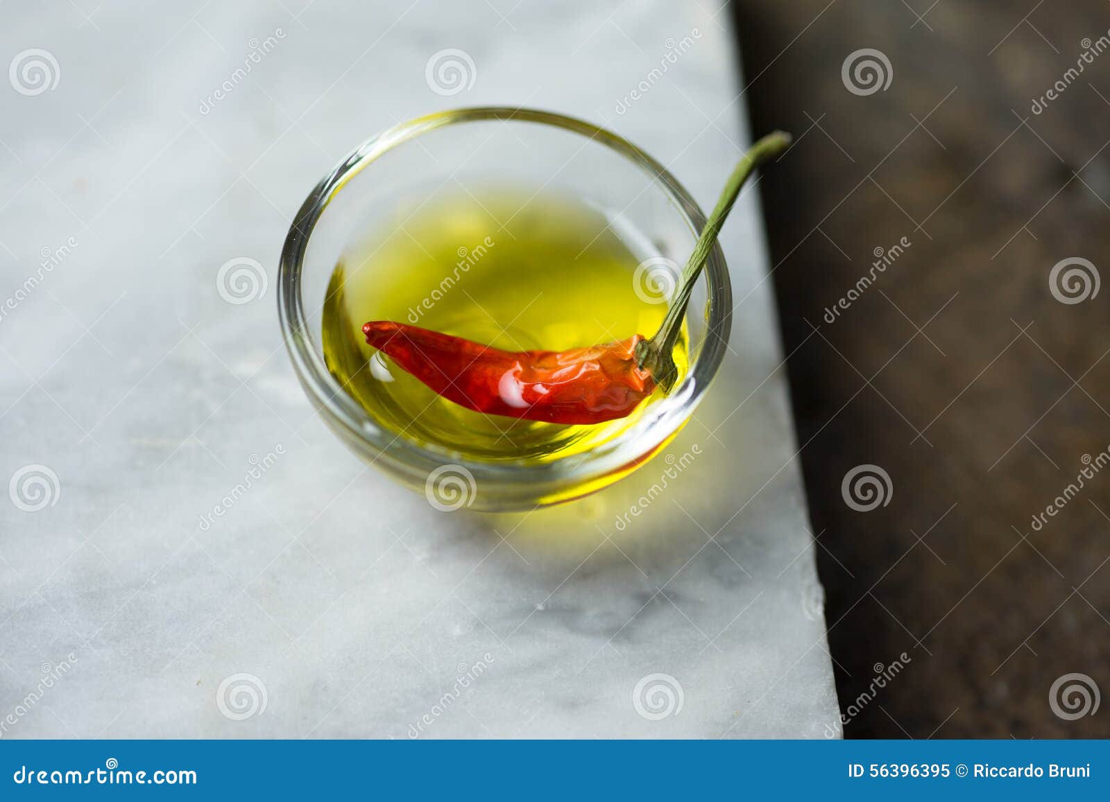 Red peppers with olive oil stock image. Image of golden 56396395