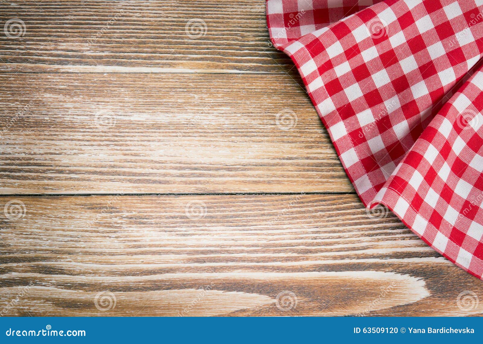 red picnic cloth on wooden background.napkin tablecloth on old w