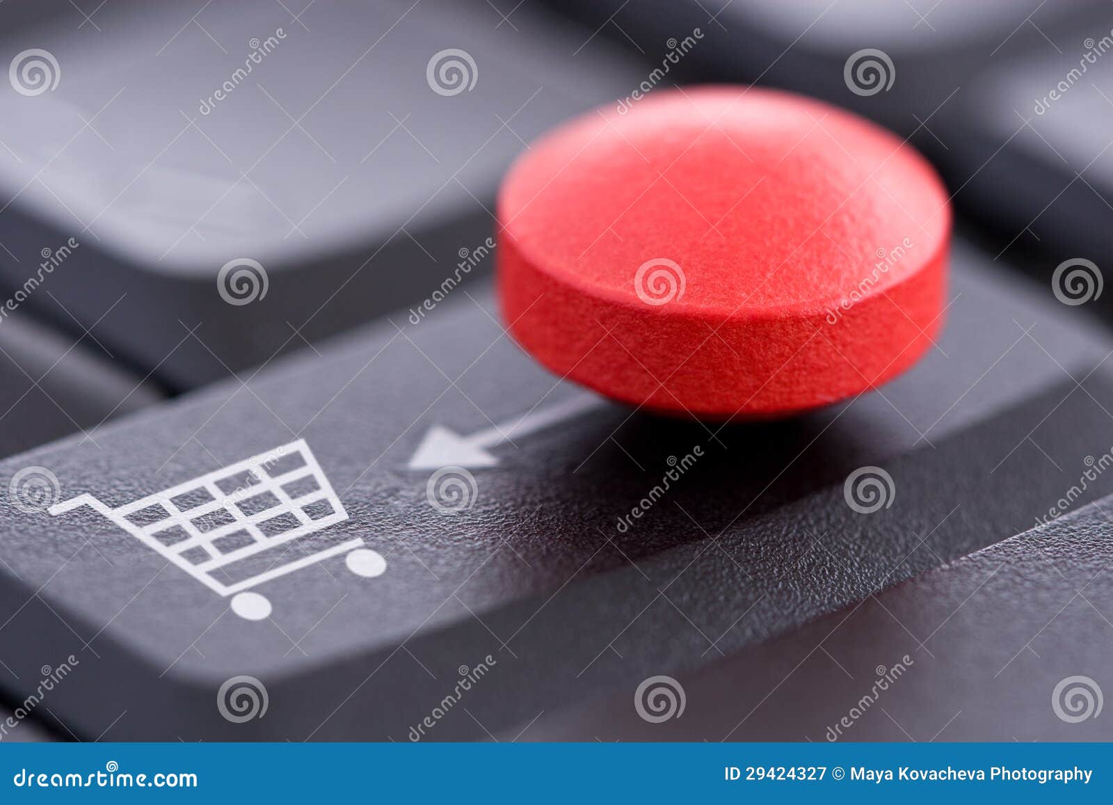 red pill and shopping cart on computer keyboard