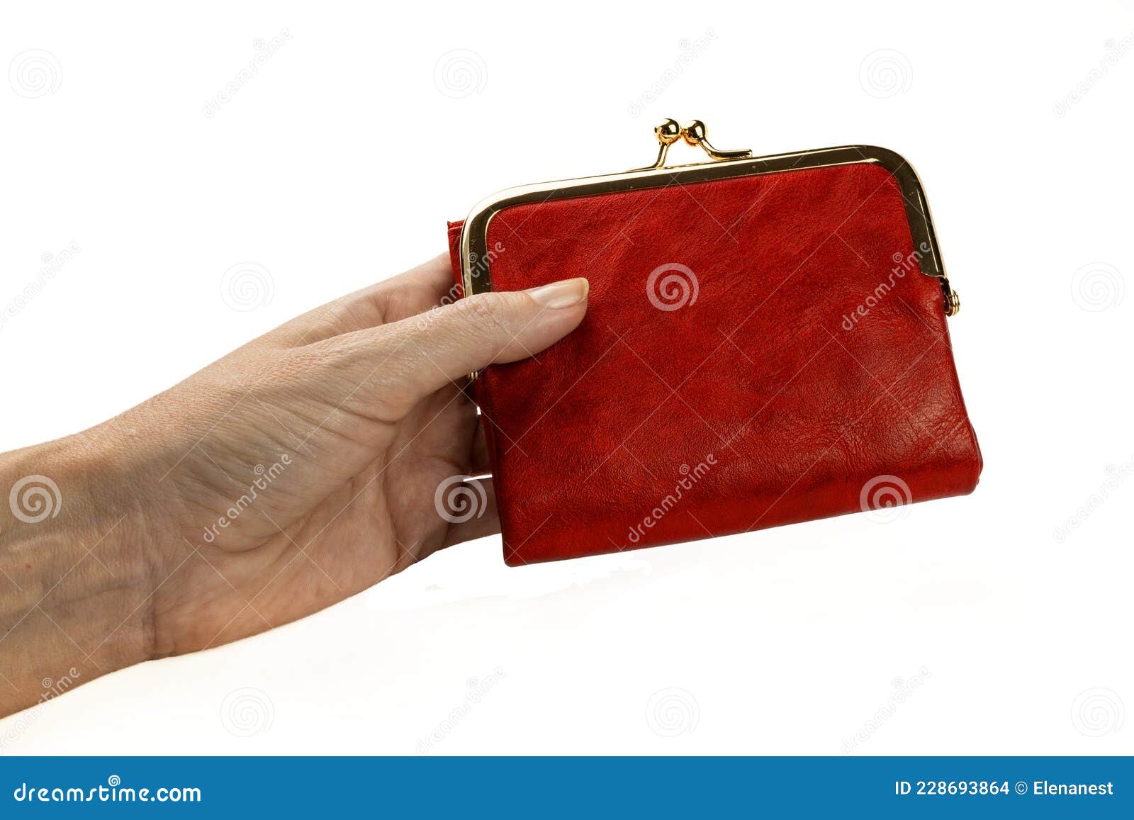 a red purse in a woman`s hand 