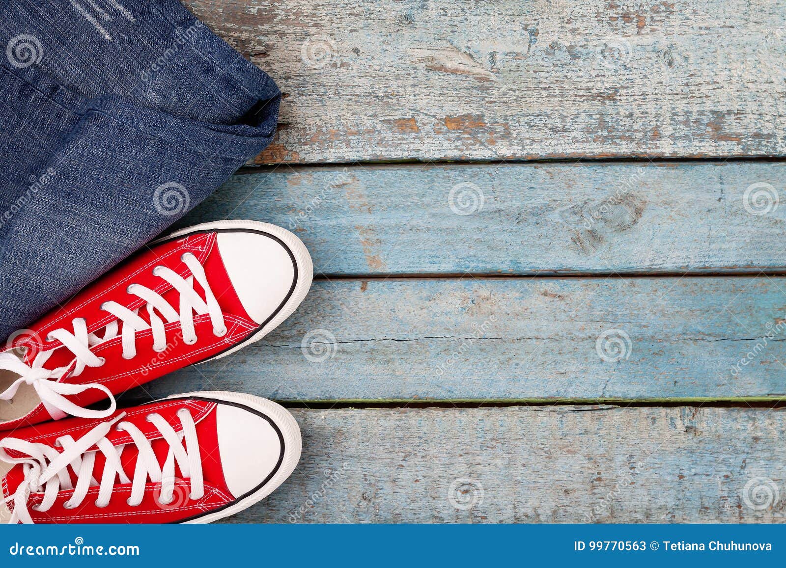 Red Retro Sneakers and Jeans on a Blue Wooden Background Stock Image ...