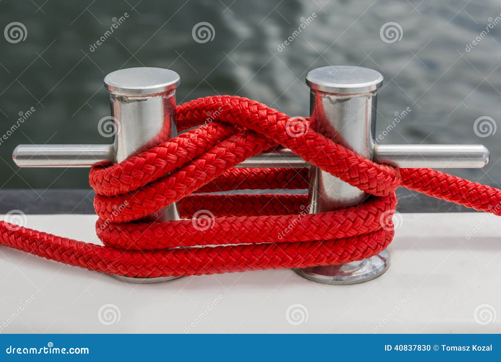 red rope fasten on stake of yacht