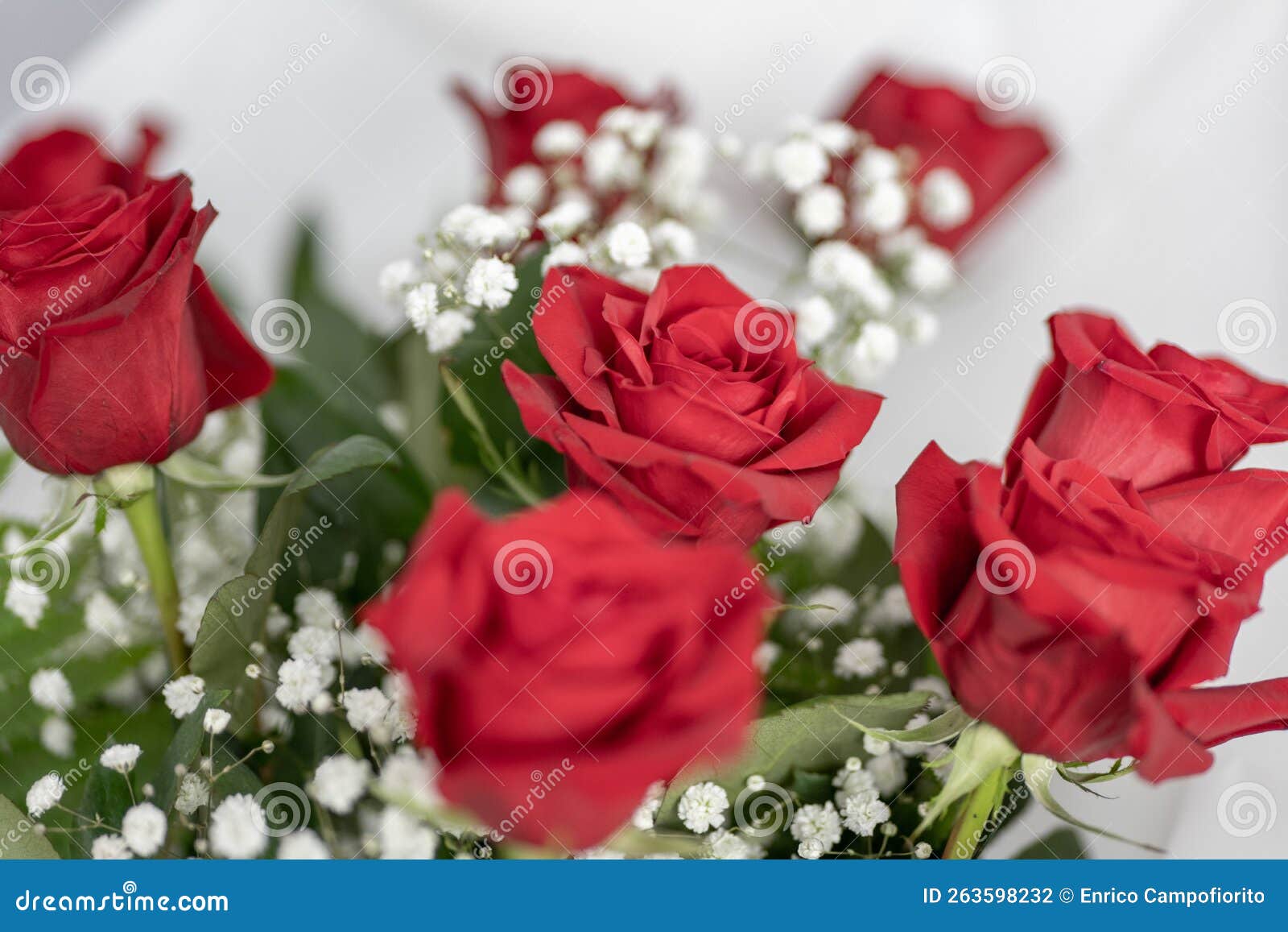 red roses and white micro flowers bouquet detail
