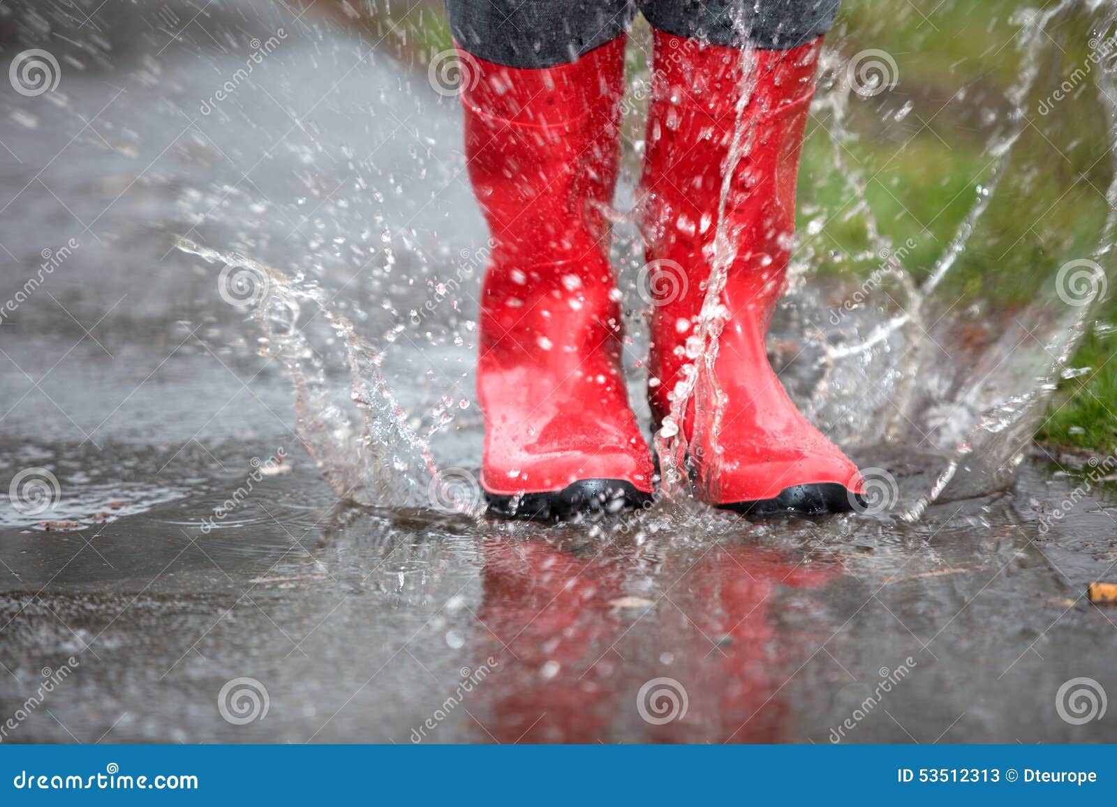 Red Rubber Boots are Jumping into a Big Puddle Stock Image Image of