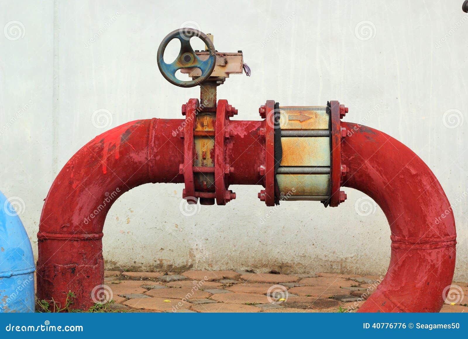 Red Rusty Metal Industrial Water Pipes with a Valve. Stock Photo
