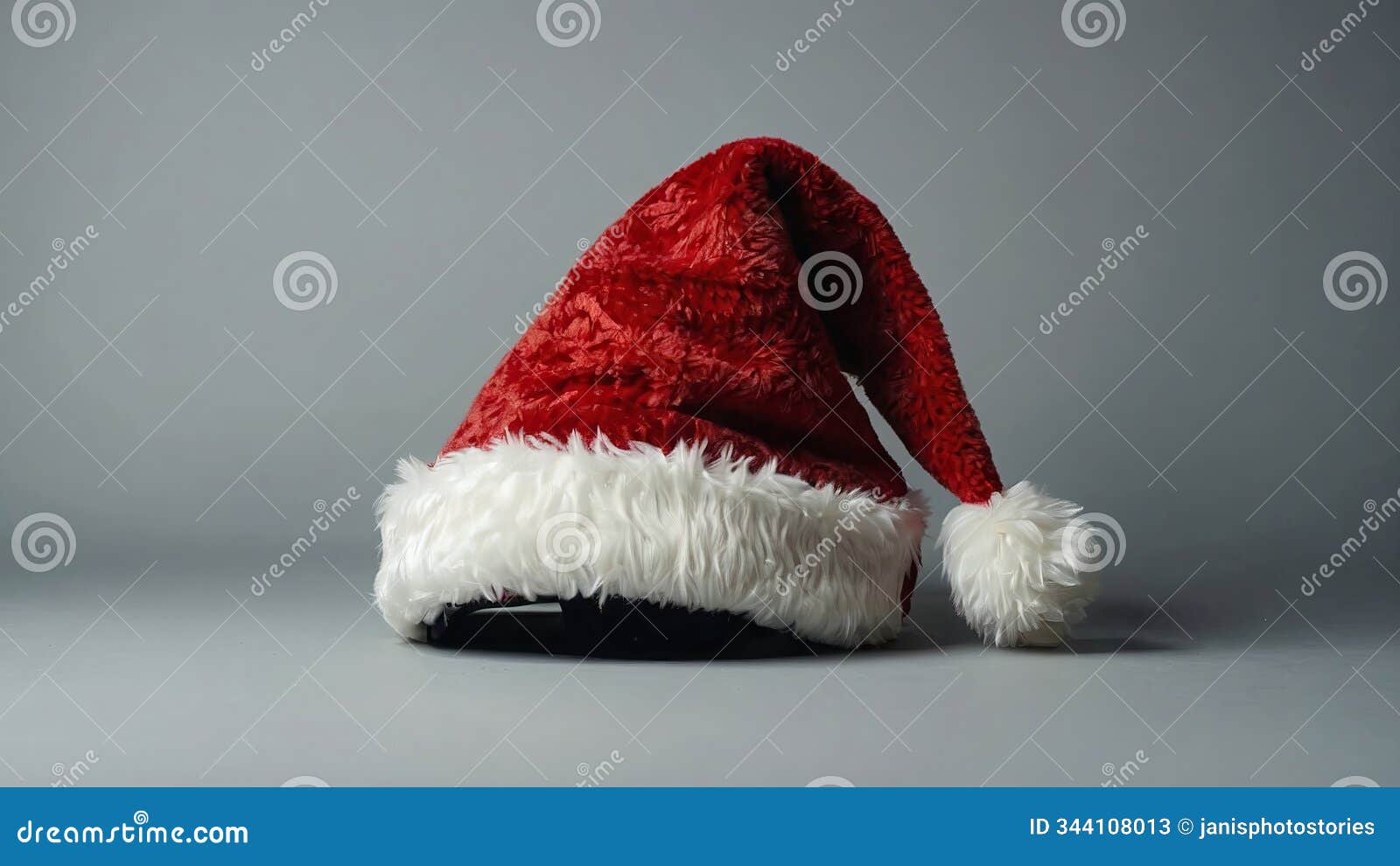 red santa hat on gray background, festive and cozy, holiday season decoration