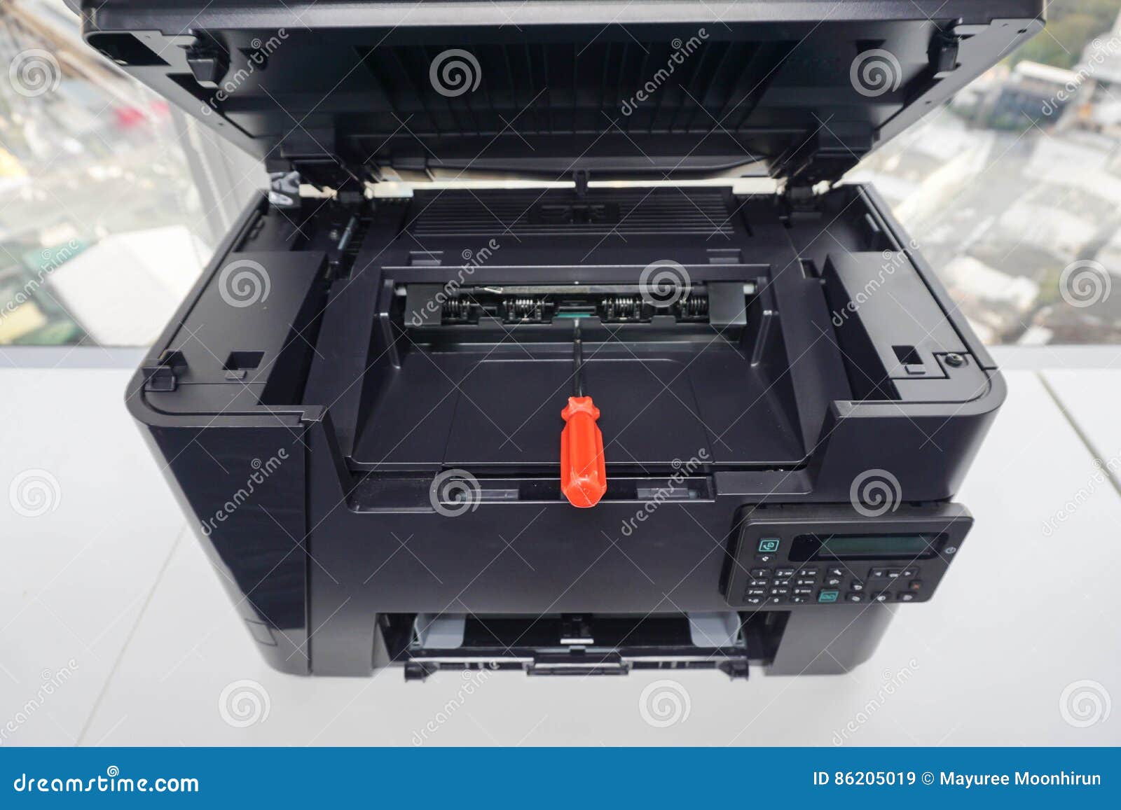 Red Screwdriver on the Printer Plate for Repair Assistance Stock Image