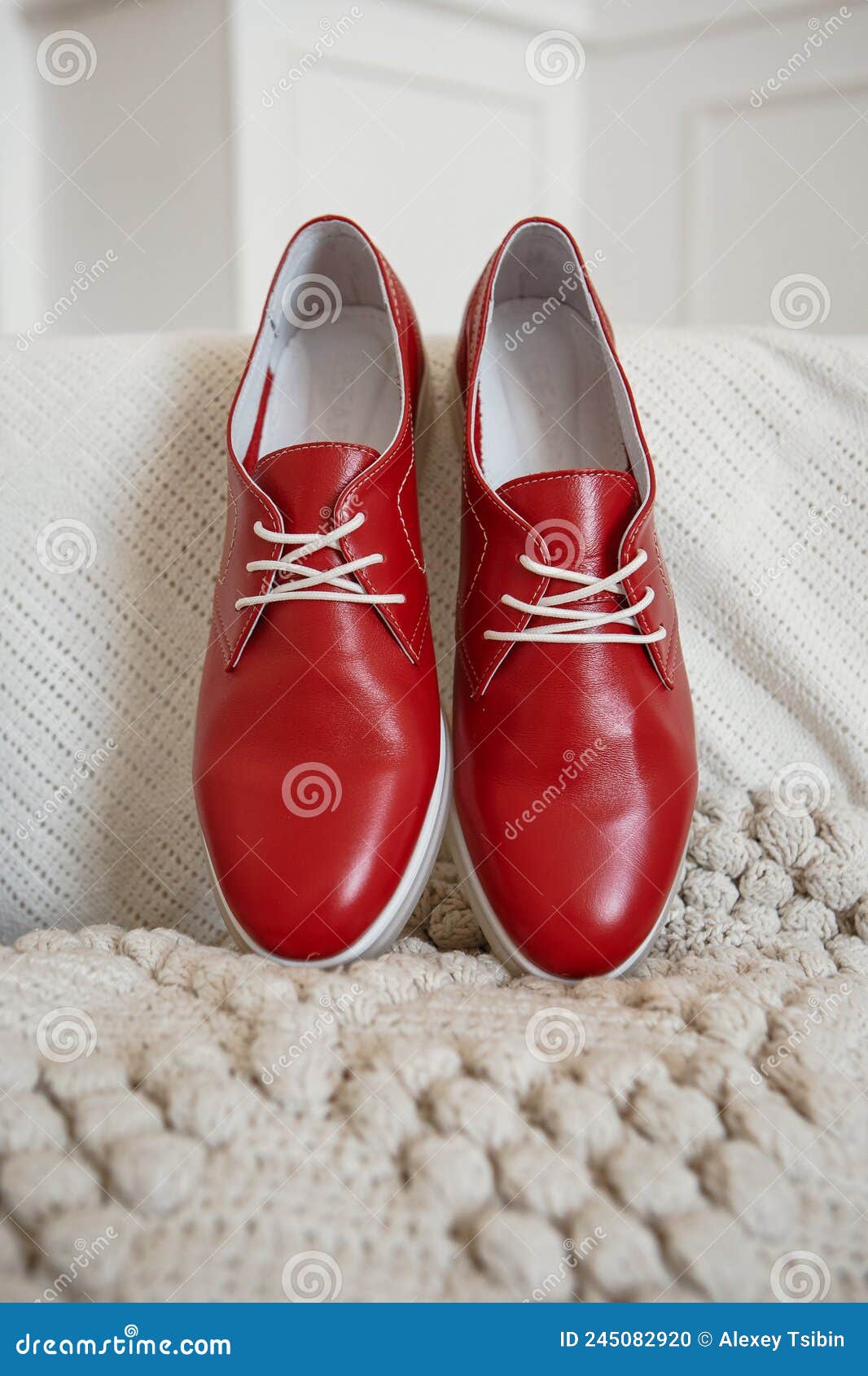 Red Shoes with White Laces, Which are on a White Knitted Scarf, Close ...