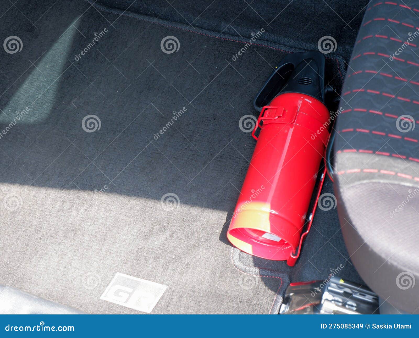 Red Small Fire Extinguisher in the Car for Safety and Prevent Fire