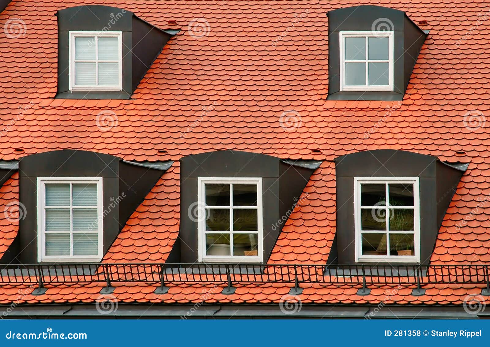 Red Tile Roof And Gabled Dormer Windows On Building In Munich