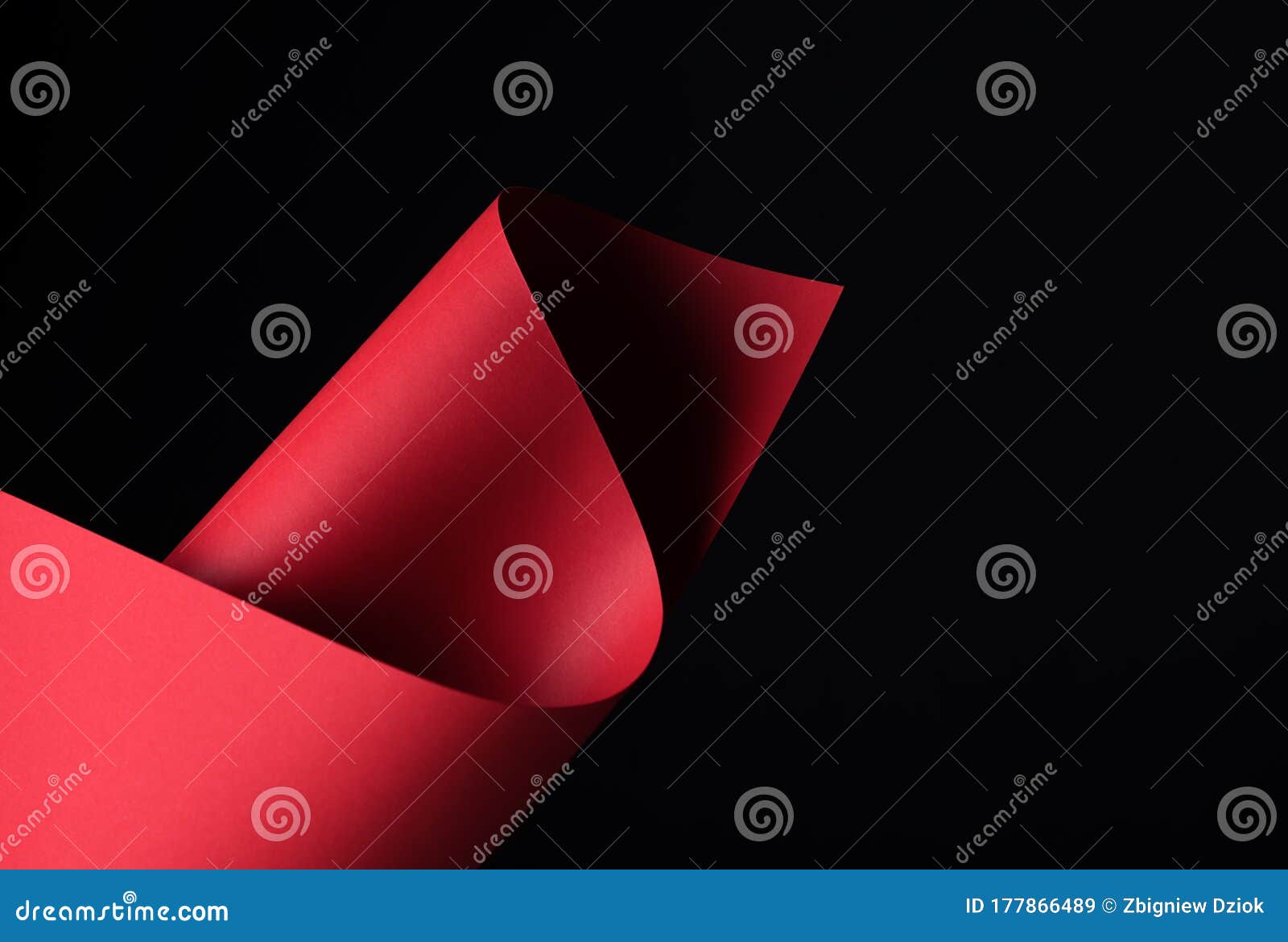 red, waved paper craft on a black background - closeup.