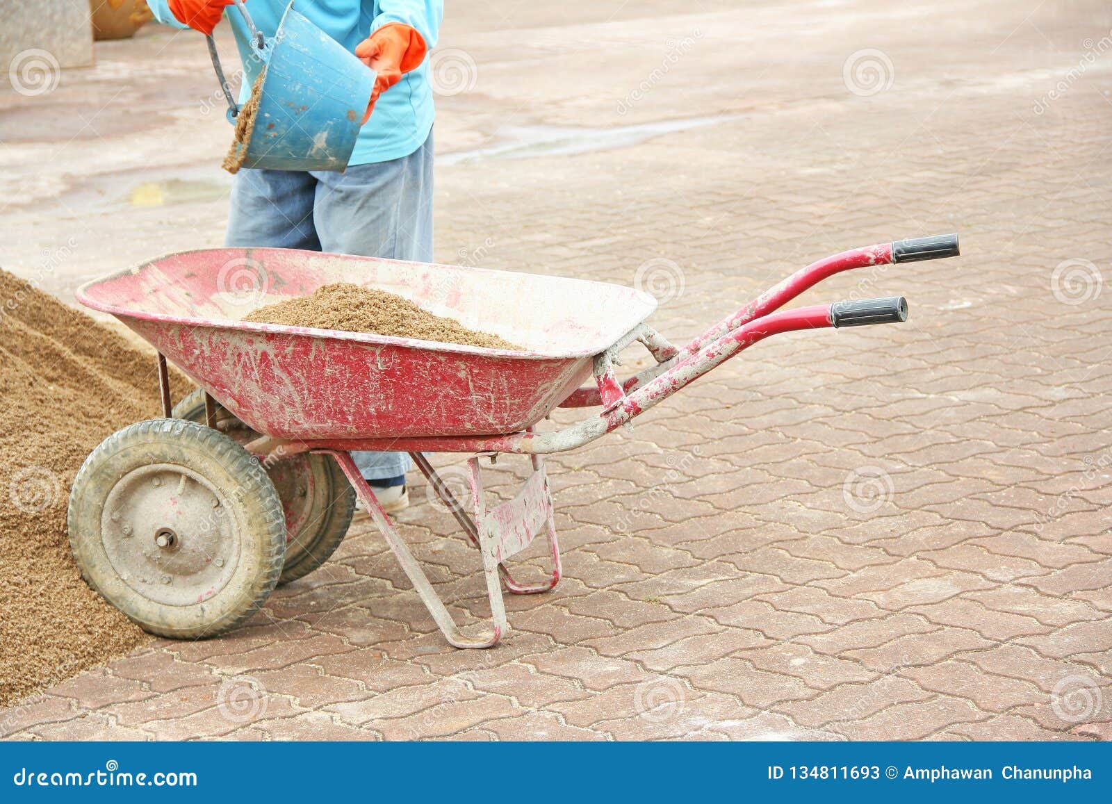 Red wheelbarrow with sand stock image. Image of mountain 134811693