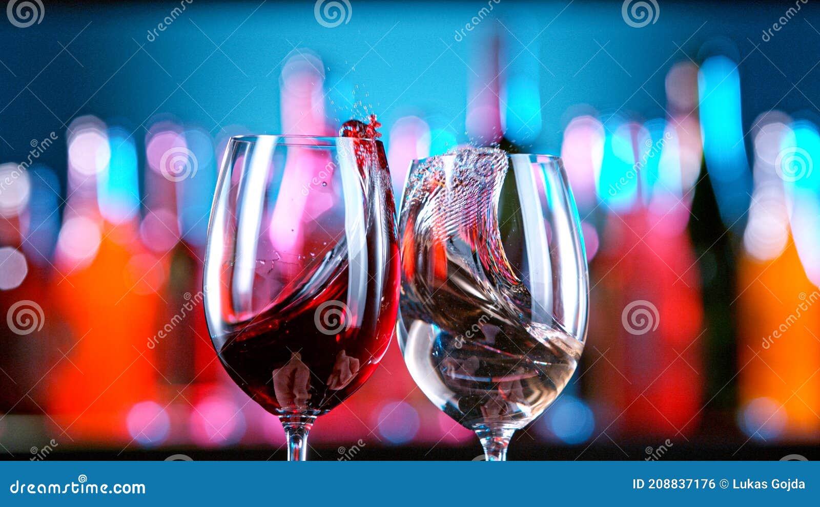 Red and White Wine Hitting Together in a Bar. Stock Photo Image of
