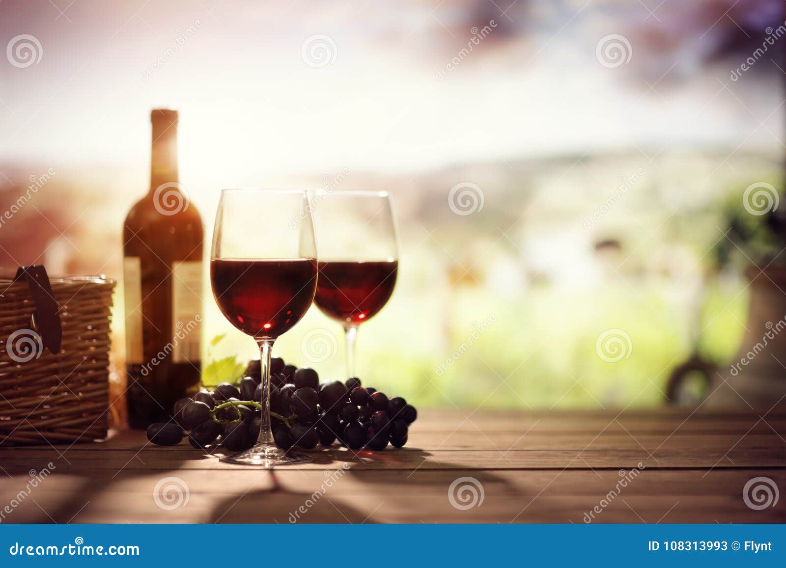red wine bottle and glass on table in vineyard tuscany italy