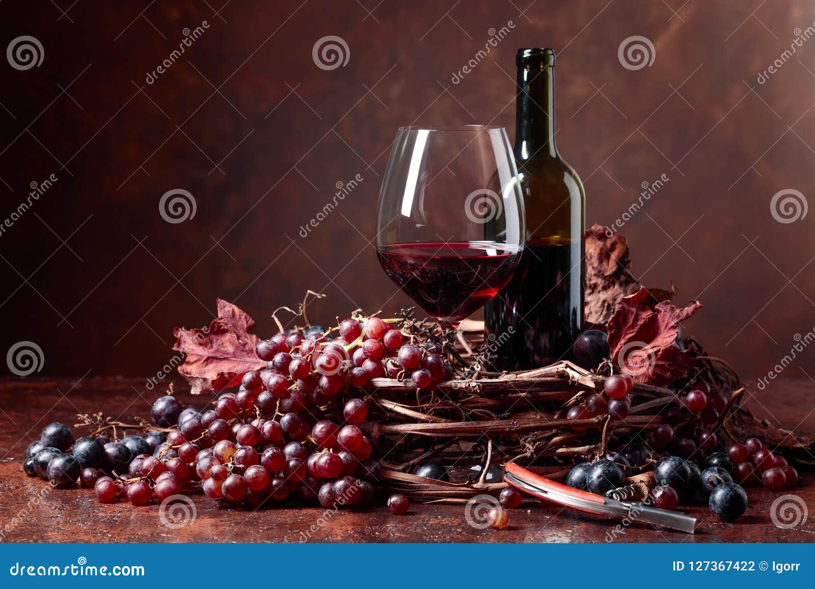 Red Wine and Fresh Grapes with Dried Up Vine Leaves. Stock Photo ...