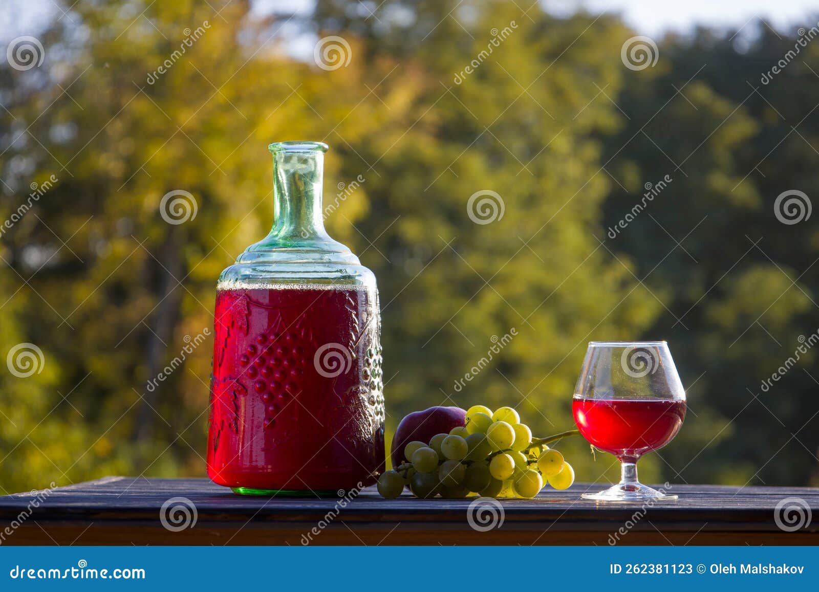 Red Wine in a Glass and Bottle. Blurred Background. Stock Image - Image ...