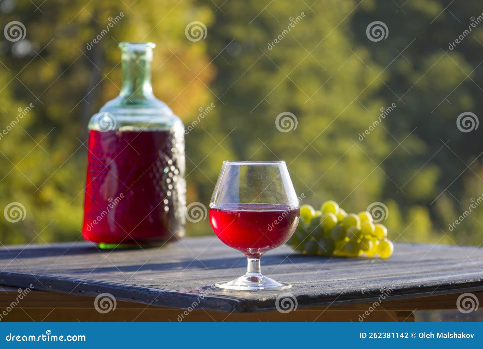 Red Wine in a Glass and Bottle. Blurred Background. Stock Photo - Image ...