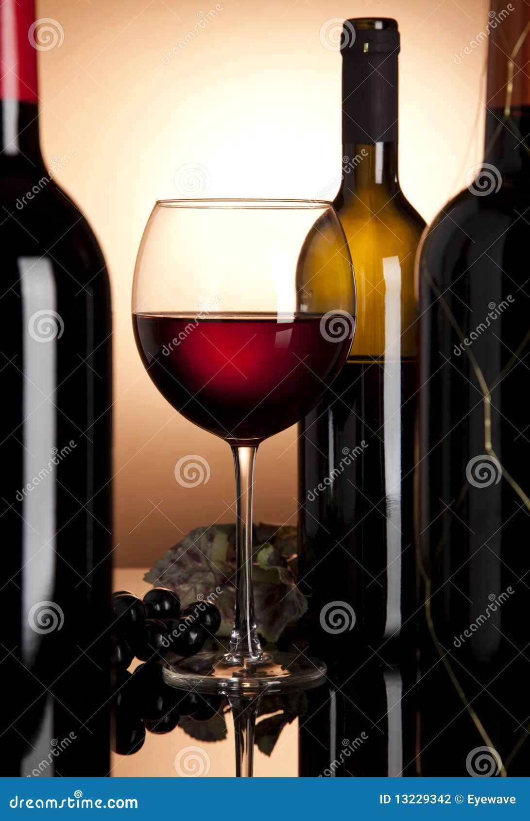 Red wine glass and bottles stock photo. Image of drink 13229342