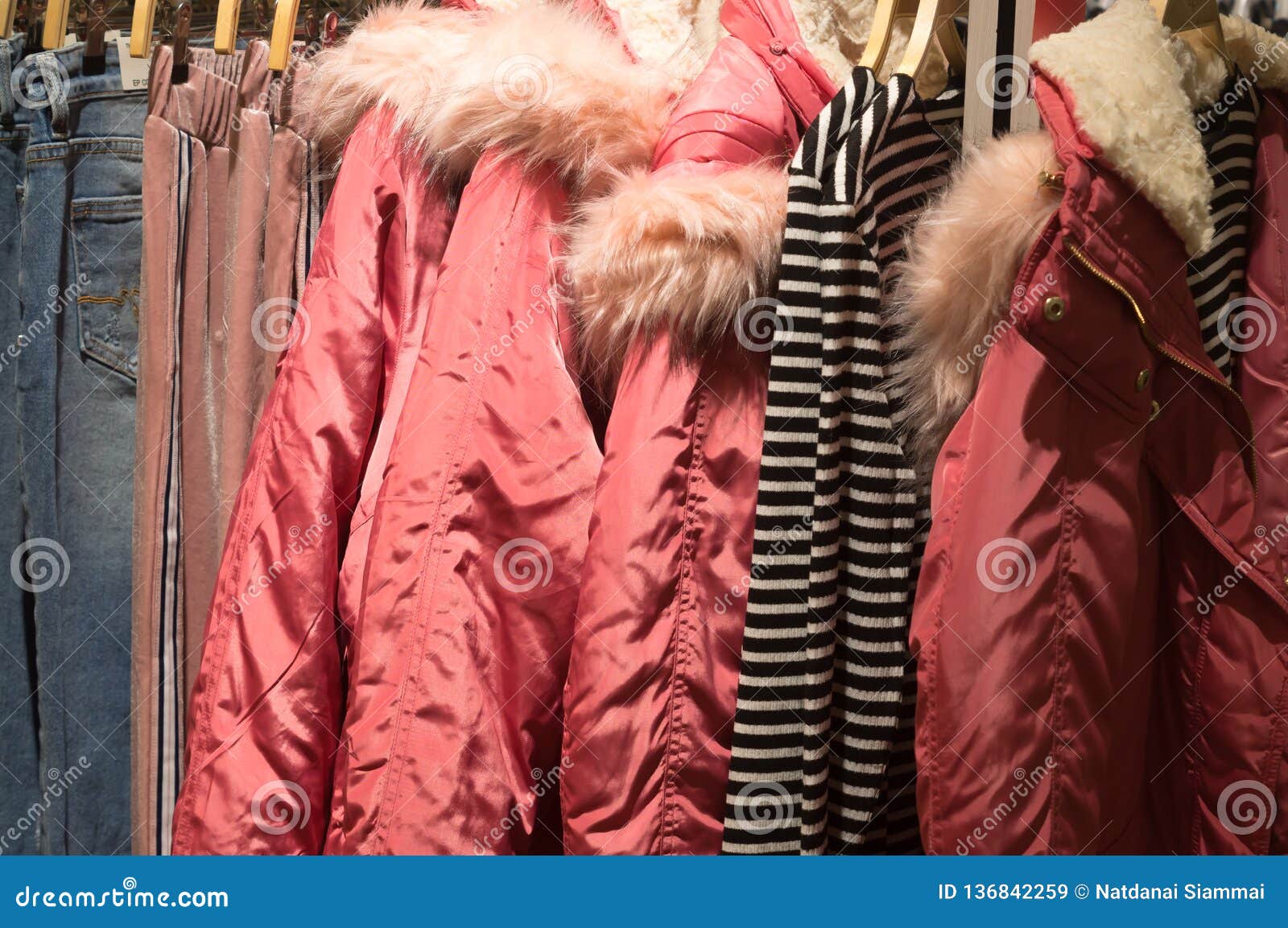 Red Winter Coats with Fur and Hood with Other Clothes Hanging on ...