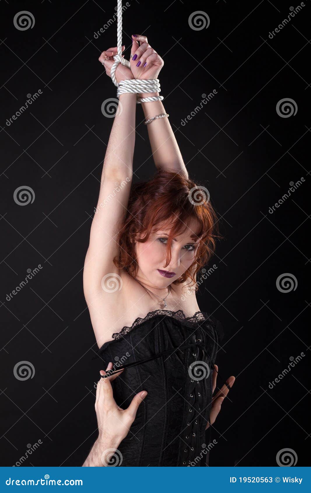 Red Woman in Corset Tied Up with Rope Stock Image picture