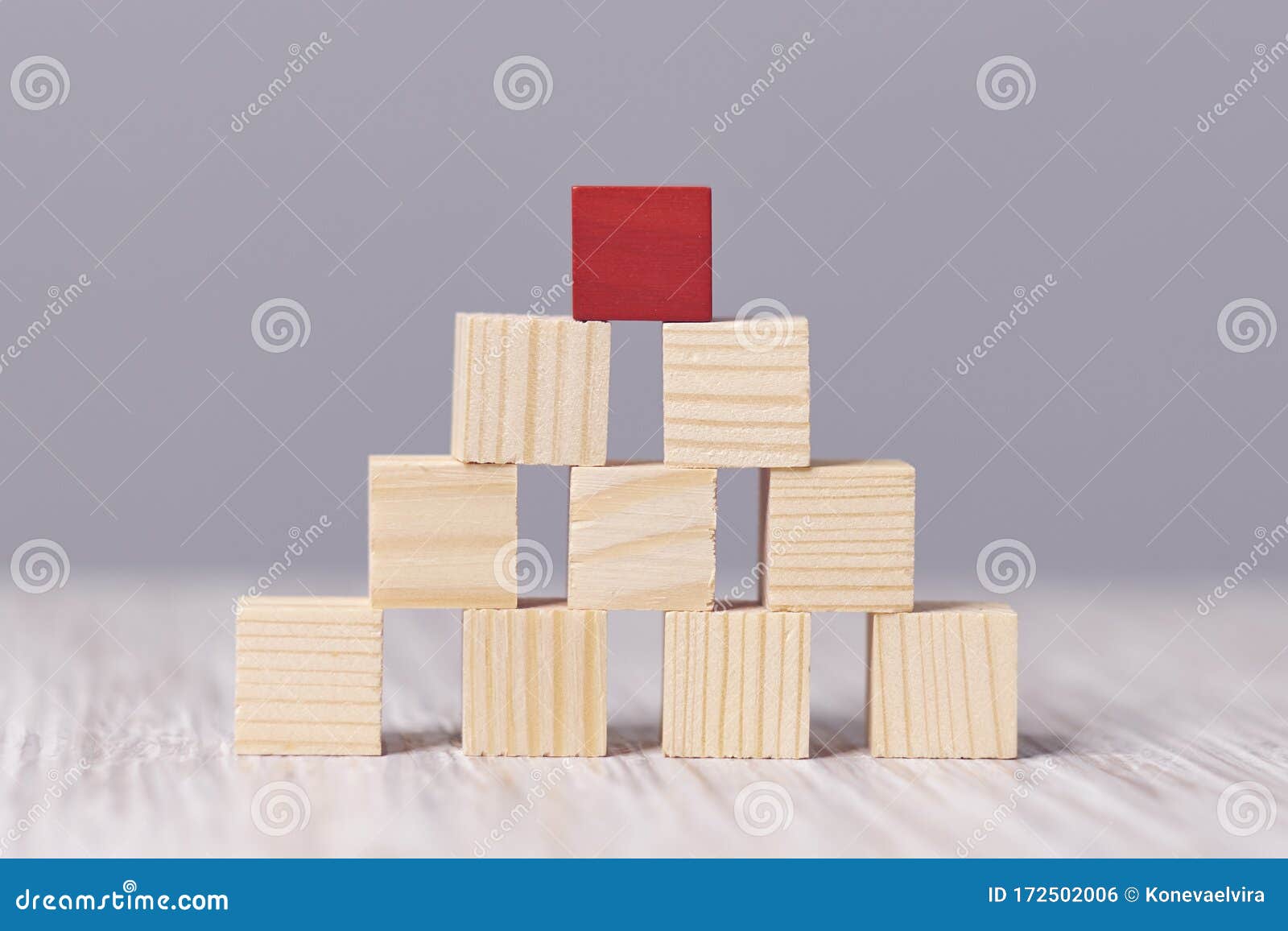 red wood cube block on top pyramid, for create icon  to success concept. hink outside the box. dare to be