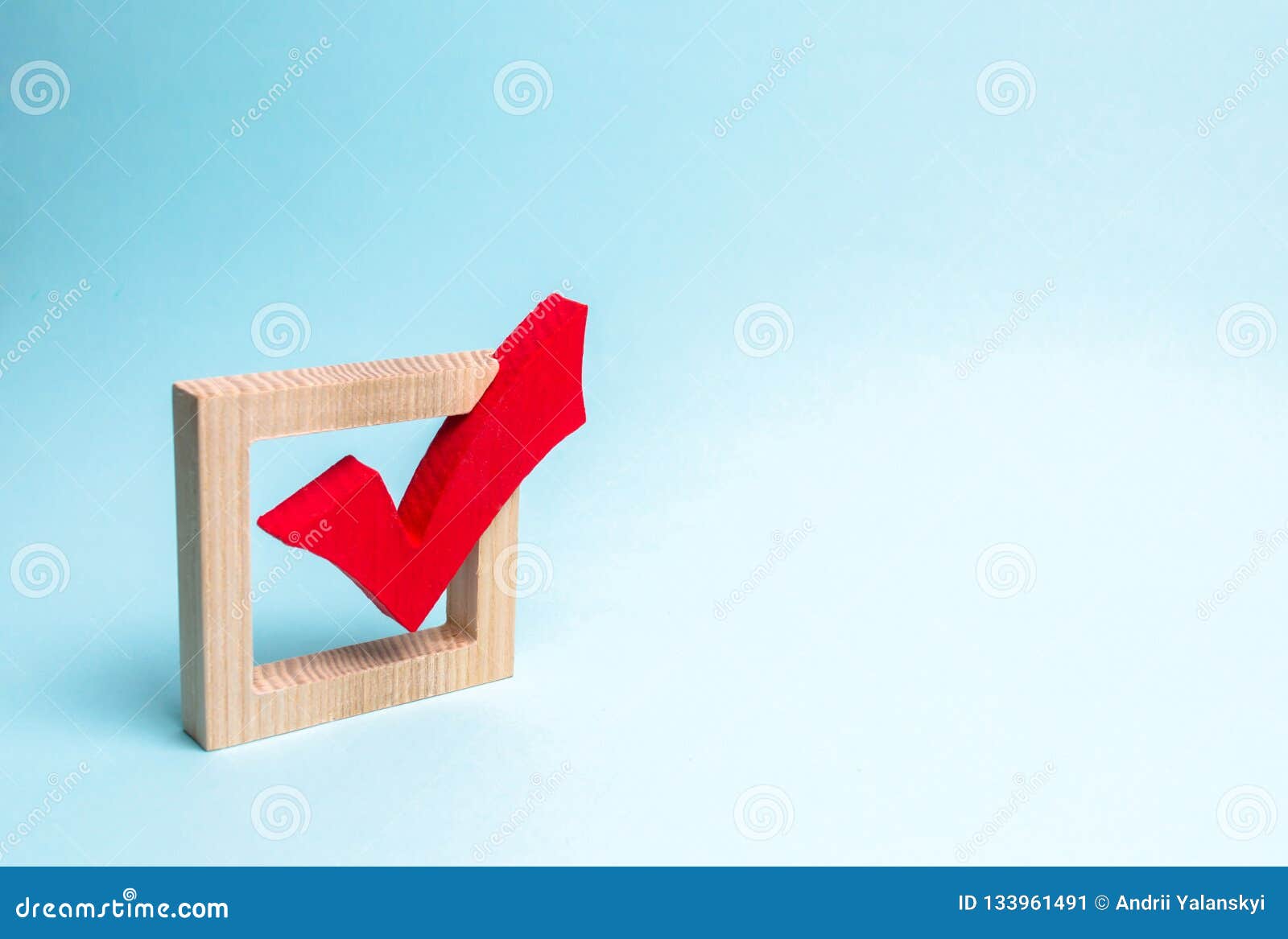 red wooden checkmark for voting on elections on a blue background. presidency or parliamentary elections, a referendum. survey