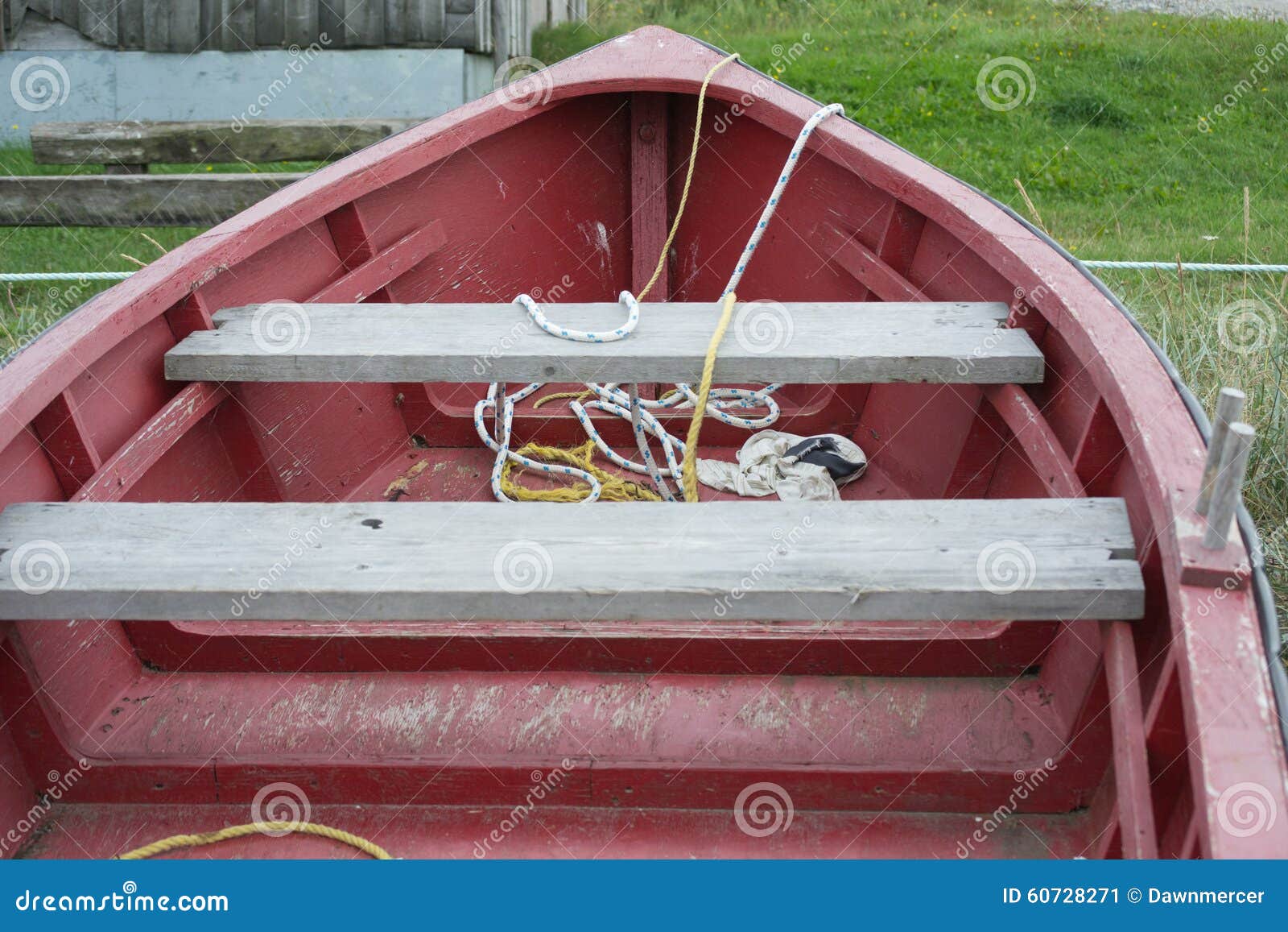 red wooden fishing boat red and yellow rope stock image