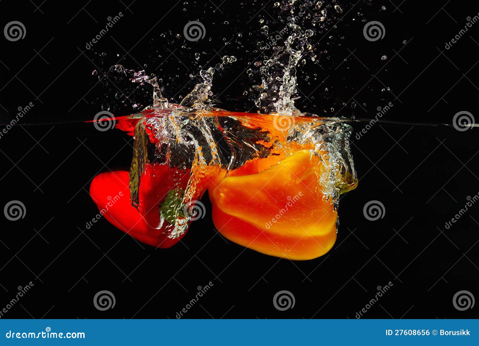 red and yellow bellpepper falling into the water