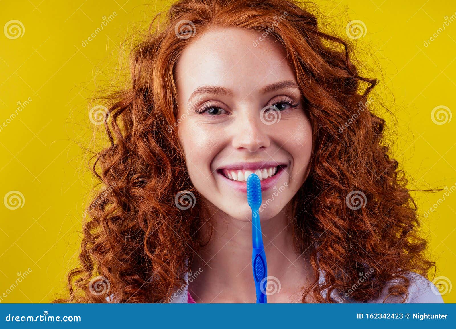 Redhaired Ginger Woman Brushing Teeth with Toothpaste Eco Paste on
