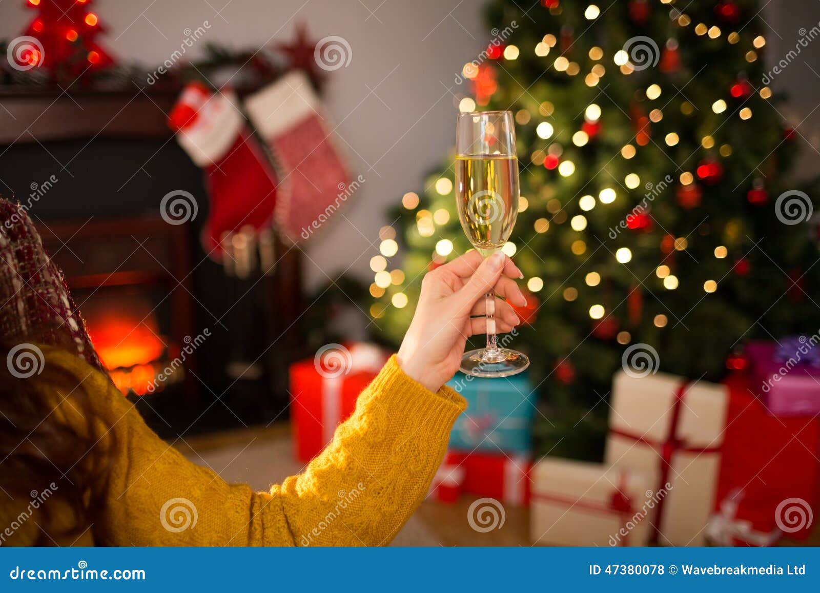 Redhead Holding Glass of Champagne on Couch at Christmas Stock Photo ...