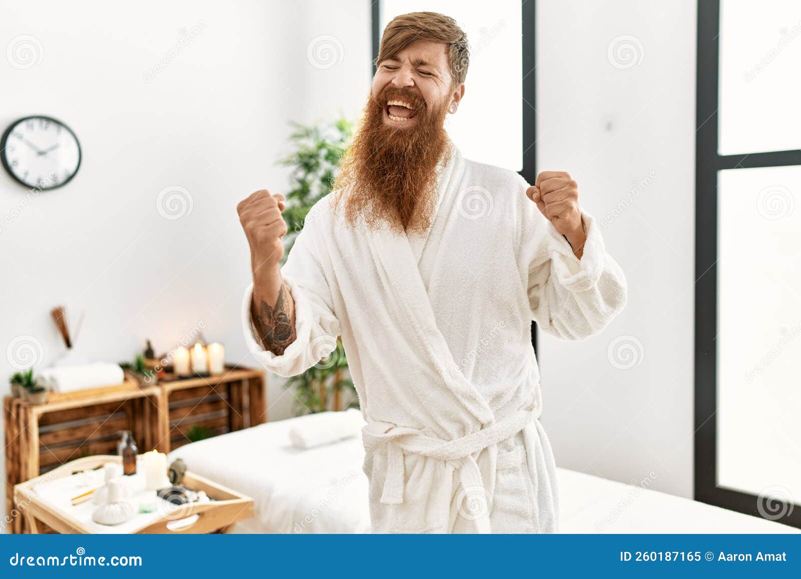 Redhead Man with Long Beard Wearing Bathrobe at Wellness Spa Very Happy