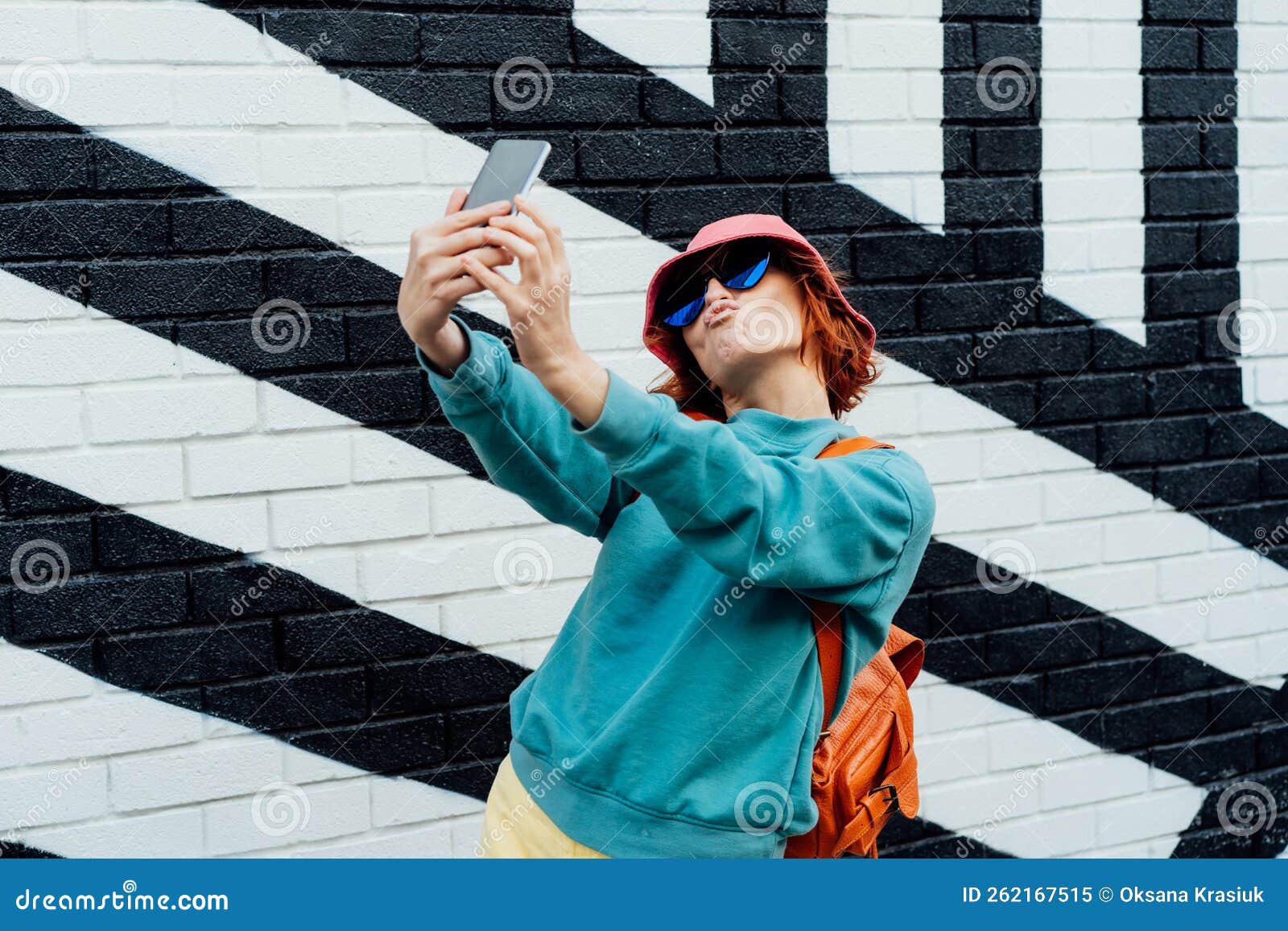 Hipster fashion woman in bright clothes, heart shaped glasses