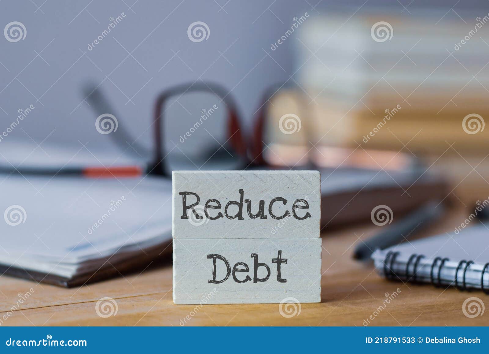 reduce debt business text written on wooden chips.