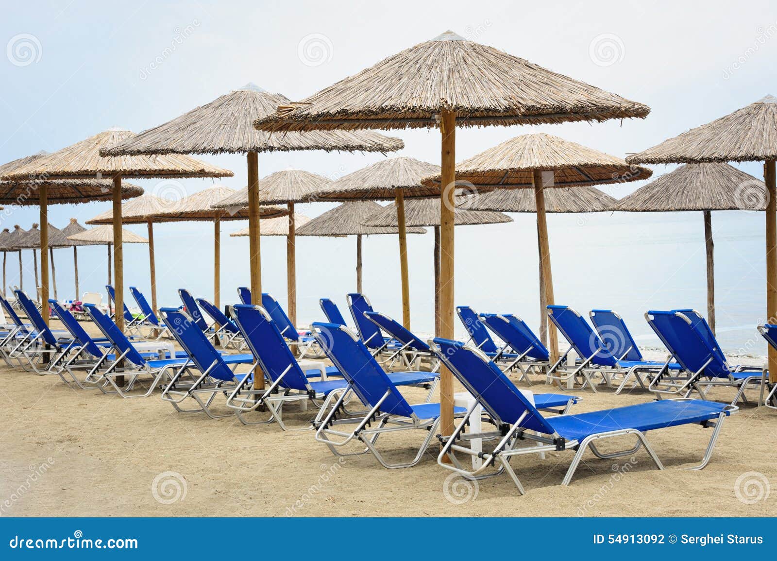Reed Umbrellas and Deck Chairs at the Beach Stock Photo Image of