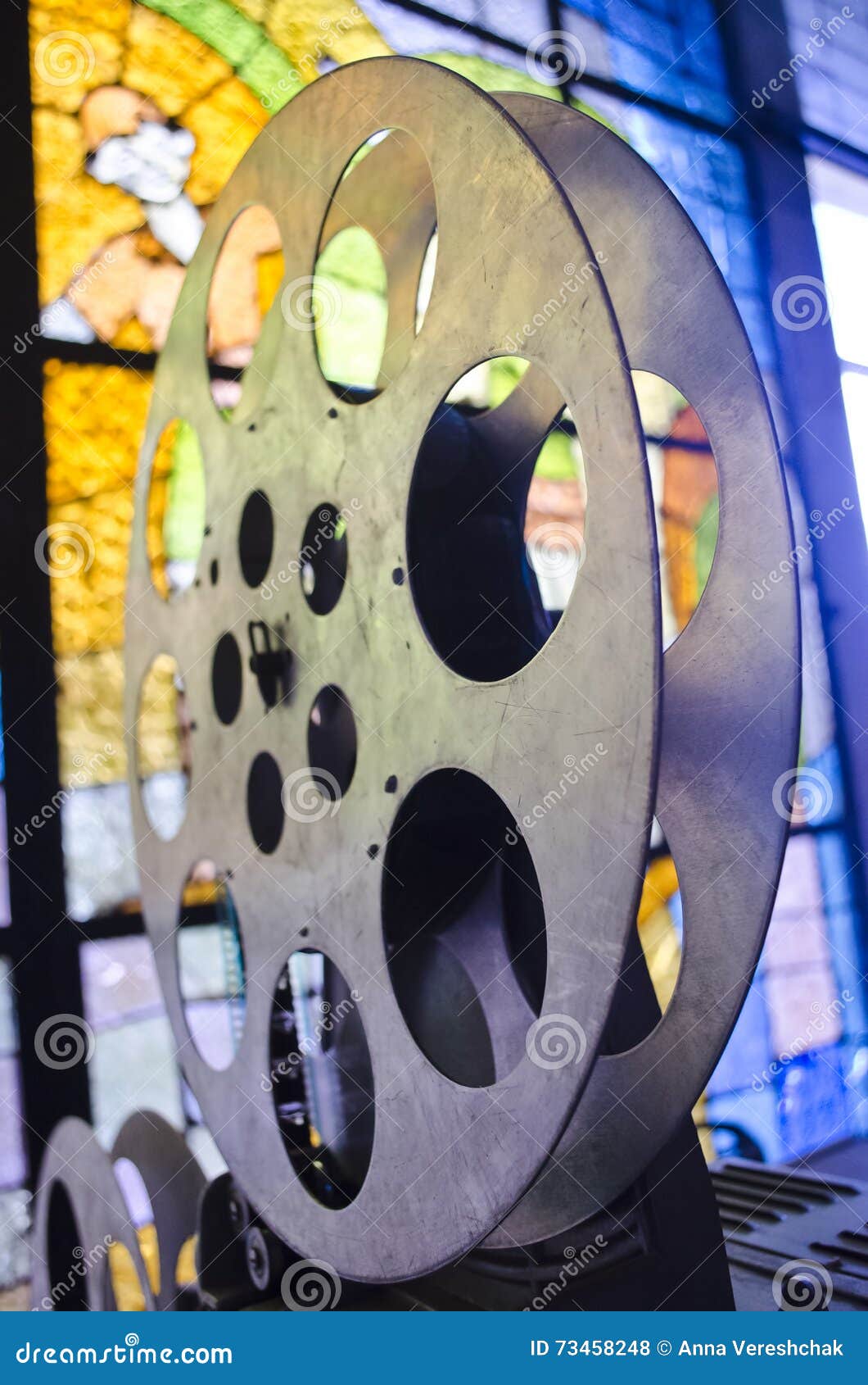 Reel of Cinema Projector. Old and Antique Part of Commercial Movie Projector  on a Background of Stained Glass Stock Photo - Image of reel, film: 73458248