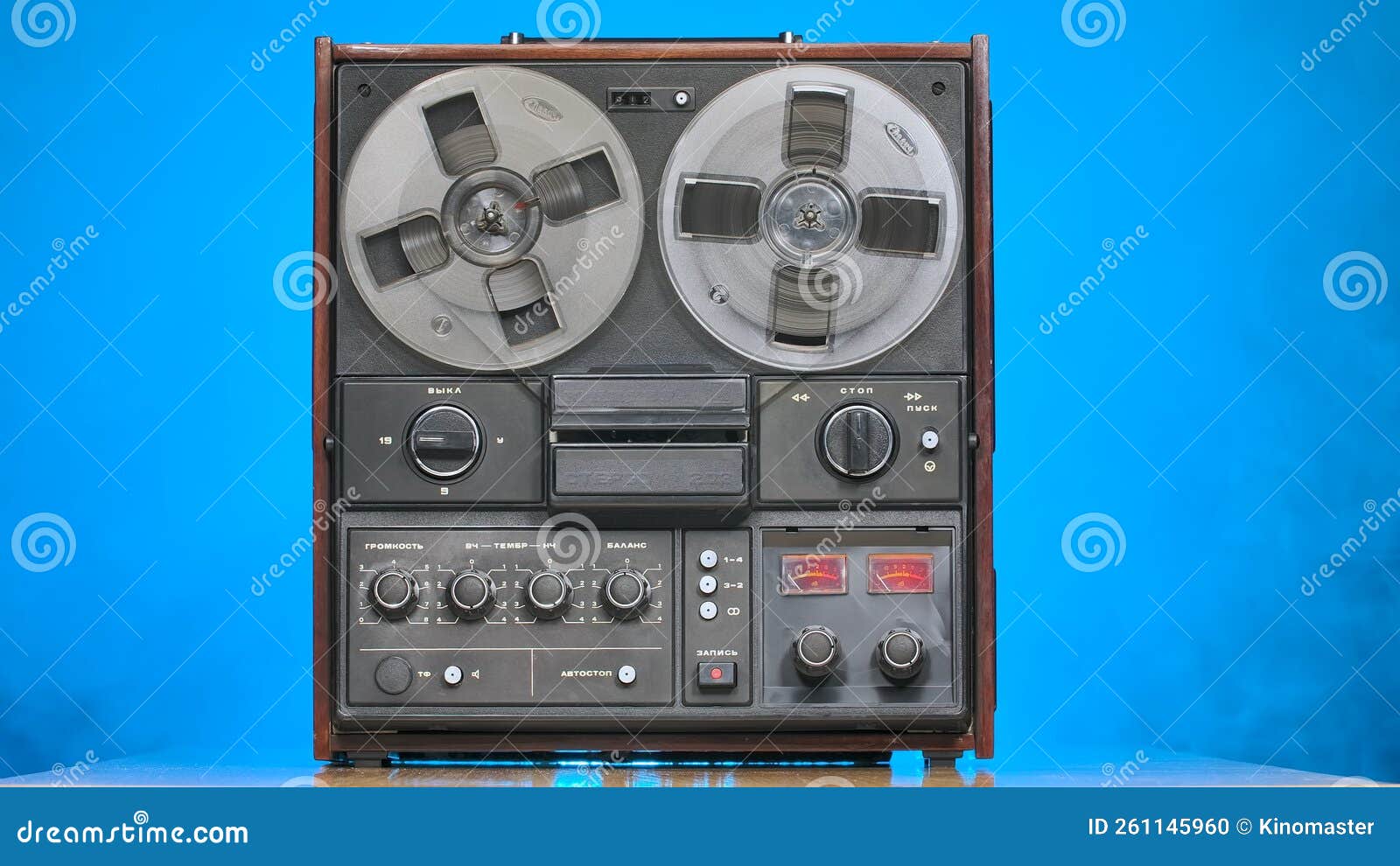 Reel To Reel Tape Recorder on Blue Studio Background. Stops