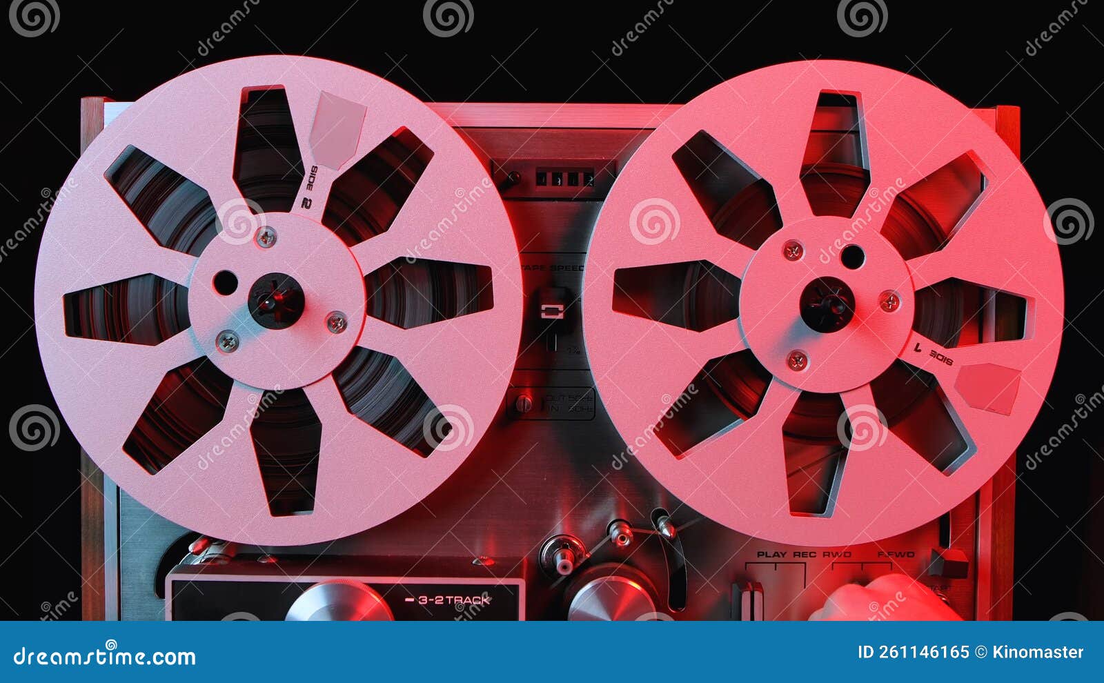 Reel To Reel Tape Recorder Illuminated by Red Light. Close Up of