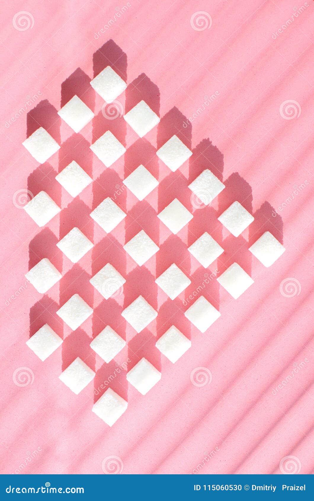 refined sugar on pink background.cubes of sweet and white sugar in geometric. hard shadows.
