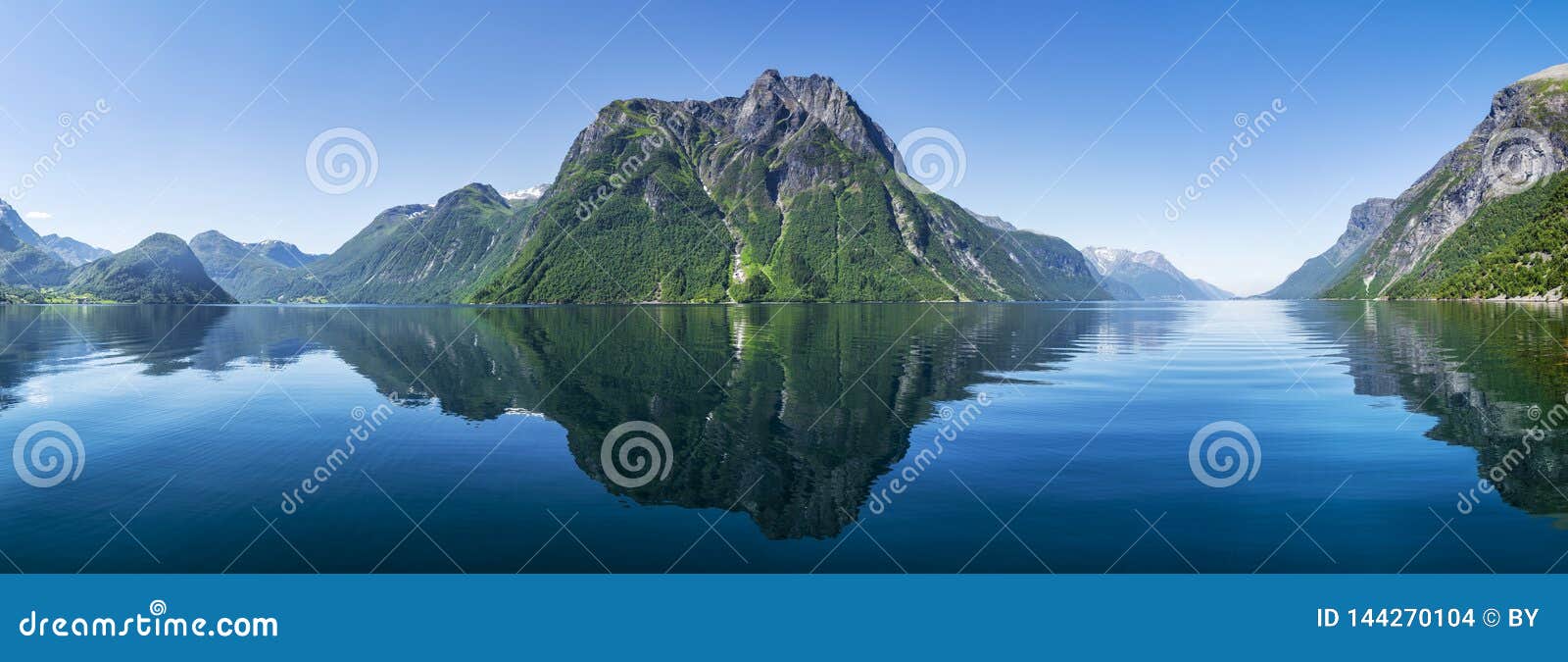 reflecting mountains at fjord in norway