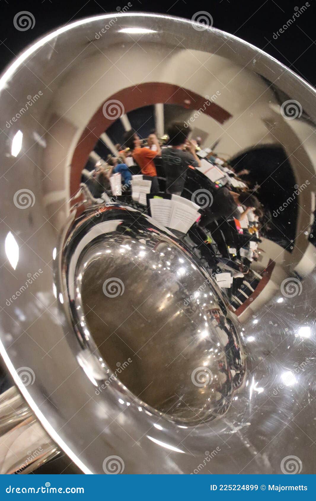 Reflection of Auditorium Marching Band Practice in a Mellophone Bell