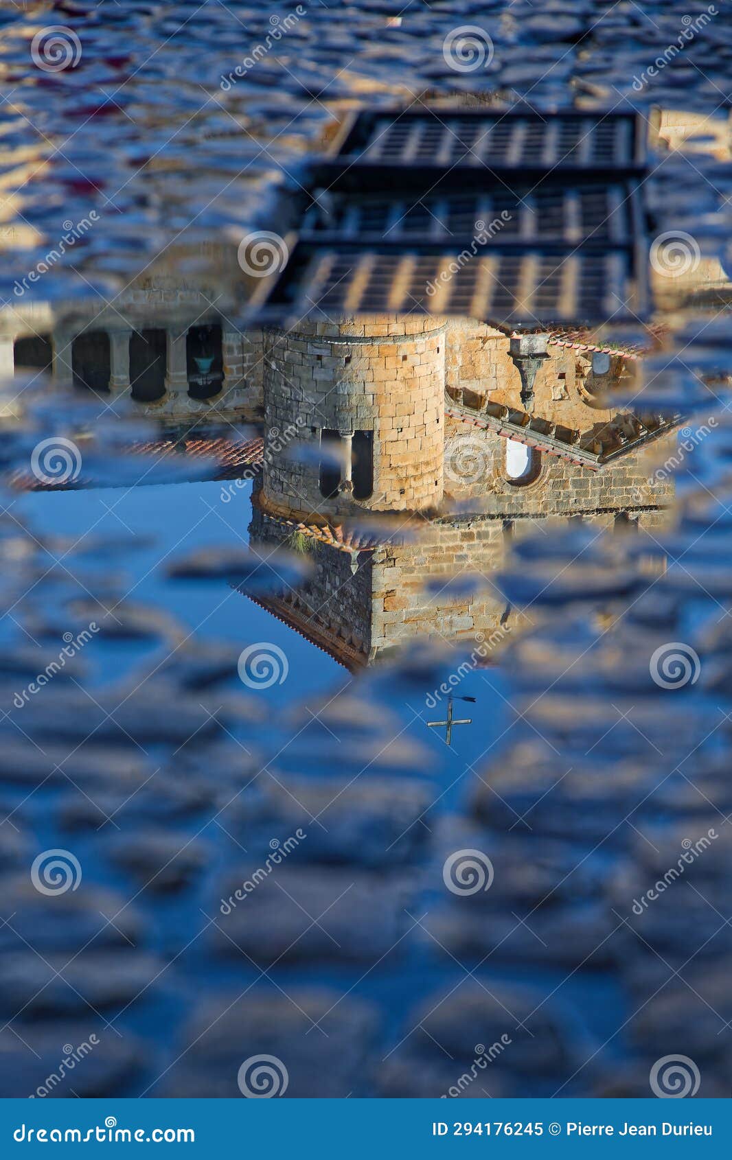 reflection of the bell tower of santillana del mar collegiate church