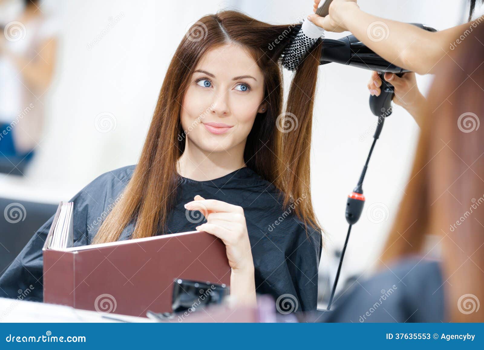 Reflection Of Hairdresser Doing Hairdo For Woman Stock 