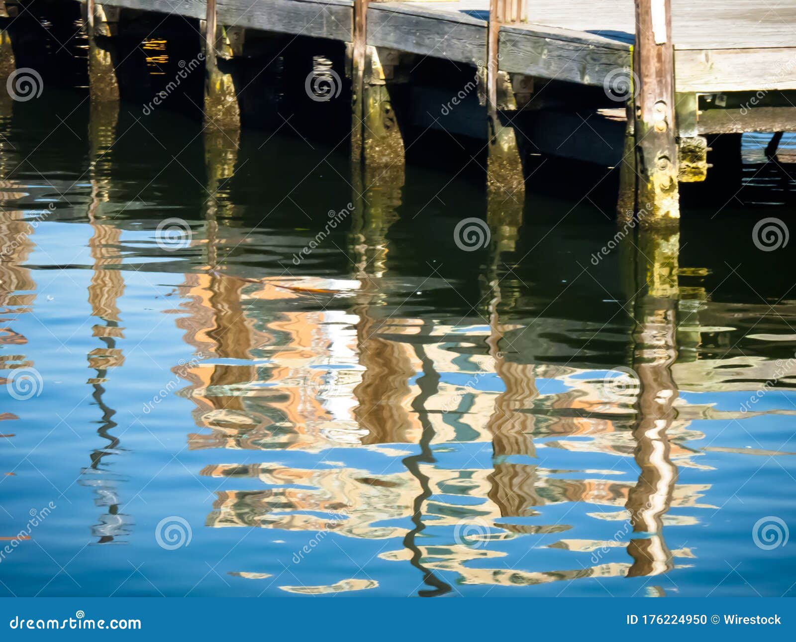 reflections of wooden posts at baltimore harbor